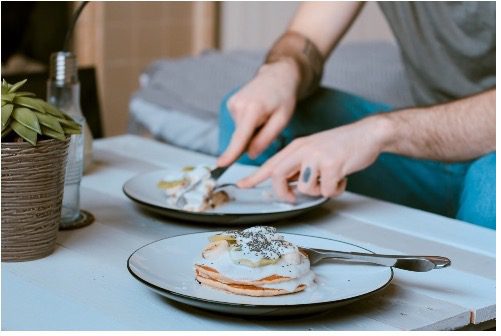 Man with ADHD cutting breakfast food